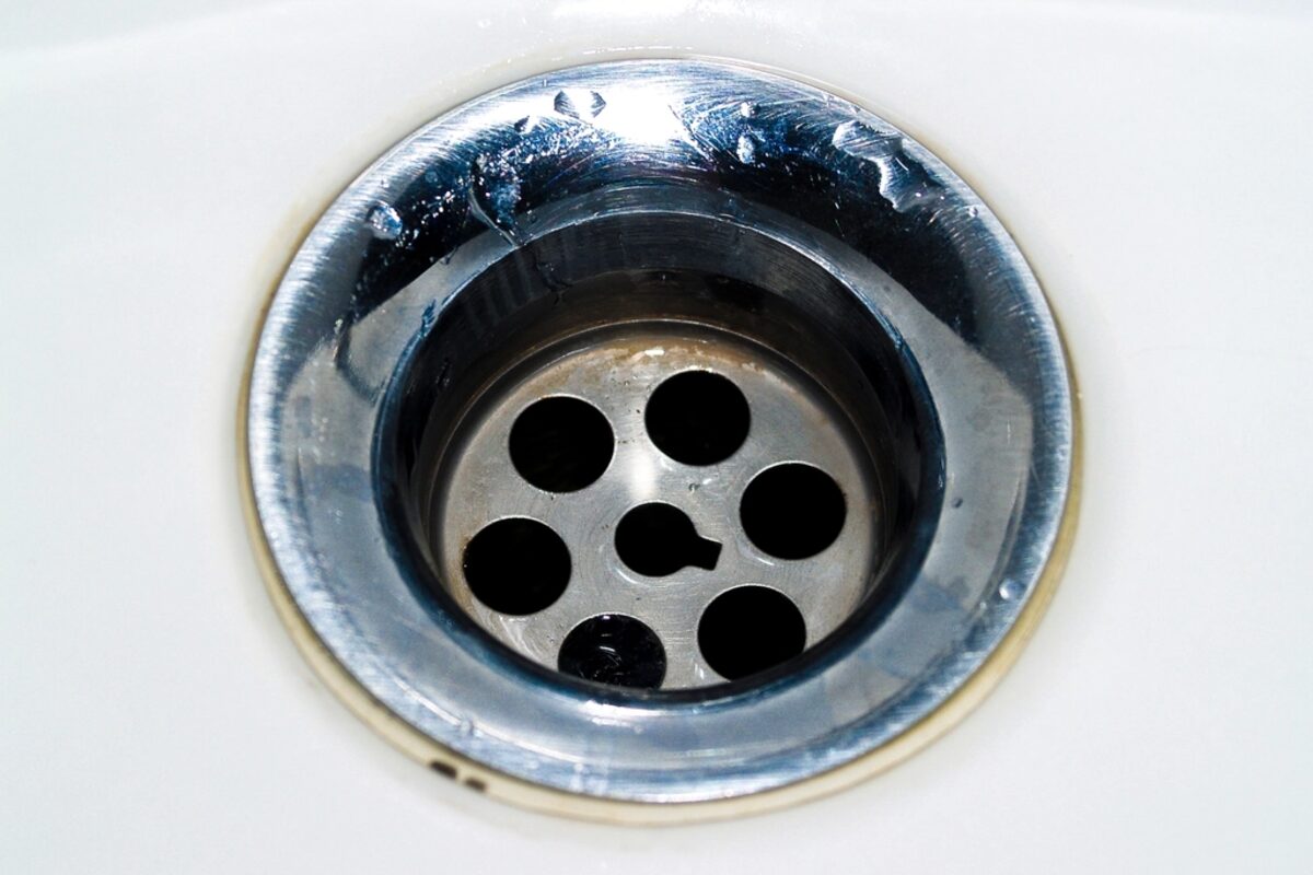 A sink drain, the fixture end of a system that runs a long way underground